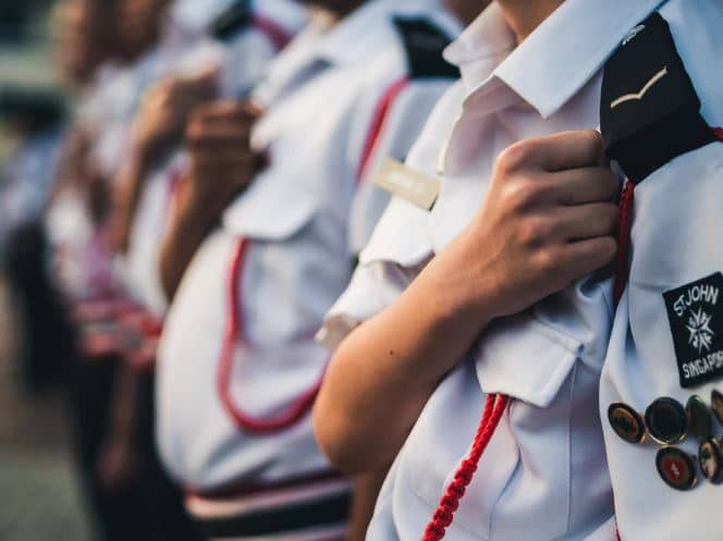 Young military cadet in uniform with his hand over his heart.