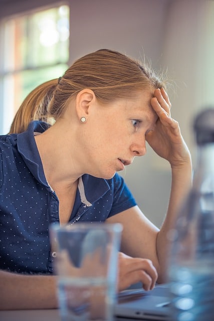 Stress-out adult working on a computer.