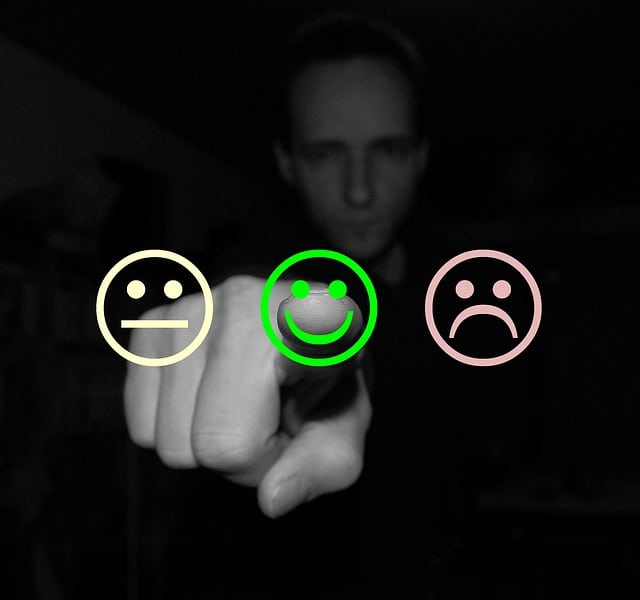 Man selection customer feedback from three different faces; happy, sad, and indifferent.